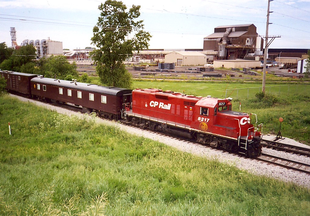 CP 8217 East passes Gerdeau and the Rte 6 overpass in Wilton, IA on 9-June-2005.