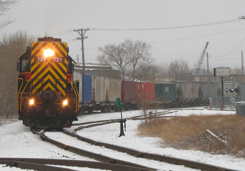 RISW-22 assists BICB-21 detour by pulling the train east down the "Golden State Route" from IC&E's West Davenport yard back to the mainline at Taylor Street.  Photo at Rockingham Rd; Davenport, IA on 22-Jan-06.