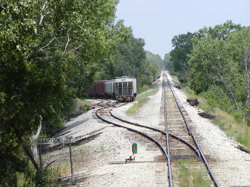 Looking east at Hancock Jct. on the prototype.  I wish I could have modeled this scene more accurately, but due to the arrangement of the room, I accepted the concession of having to put a 180-degree curve in the main at this point, hoping the heavily-wooded area to the left, when modeled, would help to disguise the curve.

Another compromise I chose to make was to move Hillis siding west to Hancock, freeing up about 15' of open mainline running between Hancock and Atlantic.  On the prototype, Hillis is about three miles east of Hancock Jct.