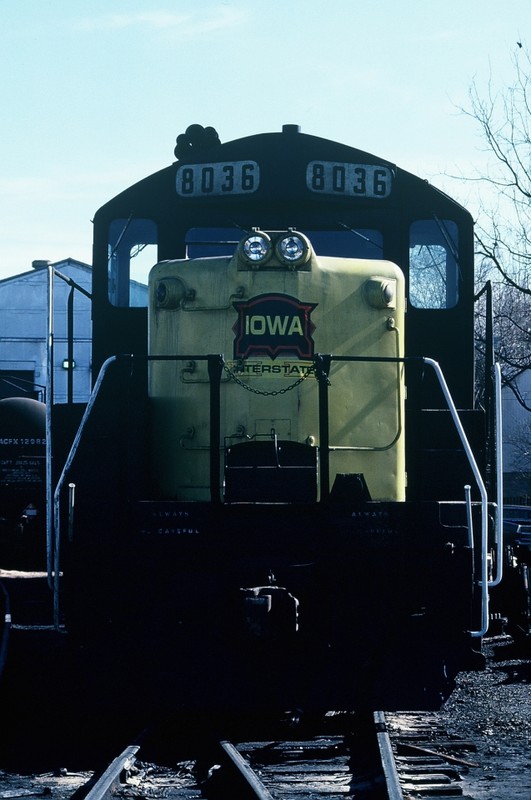 A year later (04-Feb-1987) finds 8036 sitting in Iowa City. Note the upper red and white headlamps have been removed and the red hexagon emblem has been "pasted over" with a new logo.