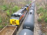 Westbound arrives at Iowa City, passing  under the Summit St. bridge.  The east train is next to it on the main.