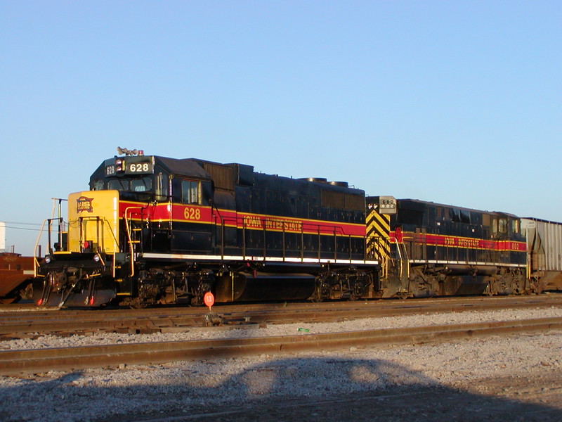 The model's prototype, IAIS GP38AC 628, shows off its newly touched-up paint, the first older IAIS unit to receive the revised scheme introduced by the refurbished 700-series GP38-2s that began arriving in August 2004.  In this photo, 628 is MU'd with M420R 802 while working the Council Bluffs switch job, CBSW, on October 25, 2004.