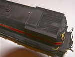The Railmaster speaker is partially visible through the radiator grill, as is the rear headlight tubing.  I dry-brushed the grill itself to simulate paint that was showing through from original owner Providence & Worcester.

The model is equipped with a LokSound #397-7240X decoder loaded with sounds recorded from the prototype IAIS M420Rs.

The dropsteps on the prototype 801 differed from those in the Kaslo kit, so I fabricated them from Cannon #2015 safety tread stock.