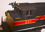 I used oils to represent a light coat of rust on top of the cab and nose.  As with the radiator grill, the faded paint on the Detail Associates #1603 P-5 horn gives away 801's heritage.

After the construction photos were shot, I realized that the prototype's grab iron on top of the nose on the conductor's side had been replaced at some point with a homemade grab, so I did the same.

The Kaslo windshield wipers were replaced with A-Line #29200 wipers.