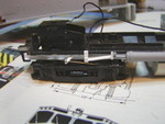 I have no idea what most of the prototype components I've attempted to model in this photo are, but the model would have looked bare without them.  I believe the brass wire represents the hand brake actuation cable, and the styrene arm extending out over the truck features a pully on the end to guide the cable as it passes down to the front brake cylinder of the rear truck.  This was all built from styrene, wire, and a few bits and pieces from the Cannon fuel tank detail set.  The frame rail itself was built from modified Evergreen 3/16" C-channel.