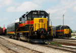 IAIS 712 and business car "Hawkeye" hold in Rock Island yard for the BNSF switcher to go by while the RISW works several tracks over on 26-Jul-2006.