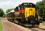 IAIS 712 pulls business car "Hawkeye" east along 5th Street in Davenport, IA on 26-Jul-2006.