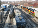 The westbound is pulling down the main at Iowa City yard, while the eastbound waits in the distance.  Dec. 18, 2006.