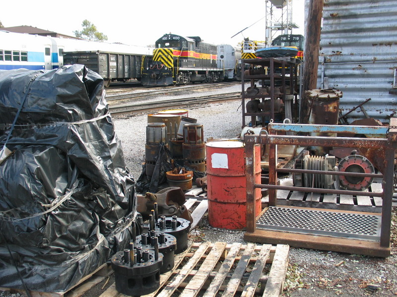 Cylinder heads, liners, drawbars, air compressor heads, misc. power and commuter cars at the west end of the Iowa City enginehouse.  Oct. 24, 2006.