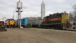 IAIS 713 (in the enginehouse) and 700, fresh from Mid American Car in Kansas City, are set up for service in Council Bluffs on December 30, 2004.  LLPX SD38-2 2805 idles alongside the road power just in from that morning's Blue Island-Council Bluffs train.