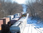 The east train is starting to pull; in the foreground on 1 track are 2 FPAX center flows (presumably for JM at Wilton, although they may be headed to one of the Iowa City plastics plants), and another ARMN for Millard's.