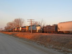 Eastbound turn, running late, passes storage cars at the Wilton Pocket, Jan. 30, 2008.