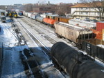 Iowa City yard.  The Chessie hopper is the one that was spotted out at Oxford the other day.  Tracks from the left are, the business car is on 5 track, 4 track is next to the enginehouse, then 3, 2, 1; the east train (with coil cars) is sitting on the siding, westbound turn on the main (with the boxcars), and not visible, north of the main, is the "north siding."
