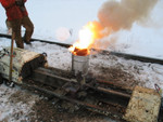 Bucket of thermite (?) flows into the joint.