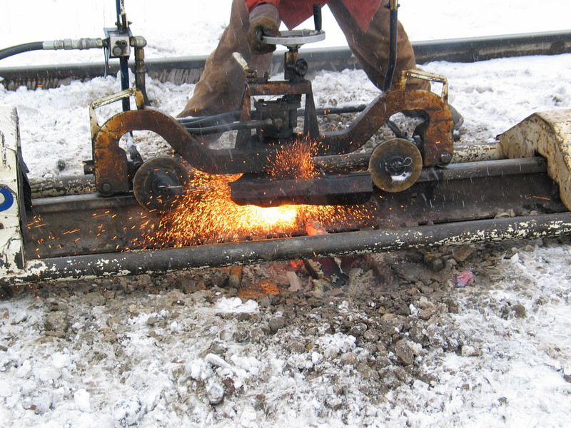 Grinding off the rail head.