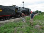 Justin  Hardecopf (in red hat) observes the action.