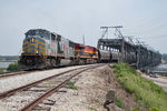 A loaded KCS grain train detour came in from Council Bluffs the night before and after running around the train in Rock Island, returns west across the Government Bridge to be delivered to the CP at West Davenport.