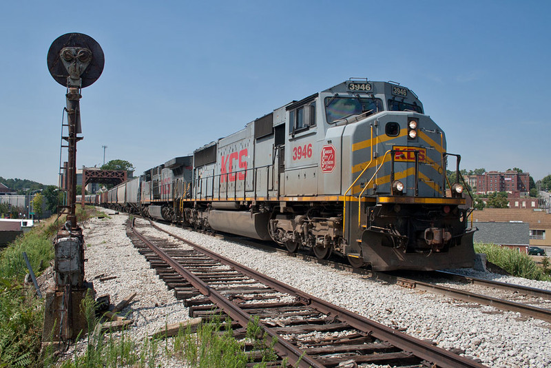 An empty KCS grain train from the CP heads east towards Rock Island through downtown Davenport, IA on August 2, 2011.