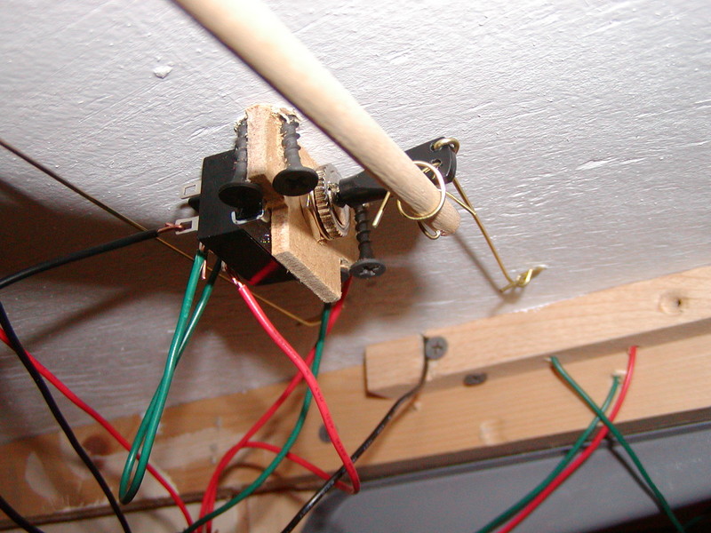 Front view showing connections of control rod and actuating wire to paddle.  To the right you can see the connection between the actuating wire and the throw wire that goes up through the subroadbed to connect to the turnout throw rod.  Electrical connections have all been soldered since this photo was taken.