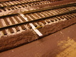 View from above of the throw wire and its connection to the throw bar.