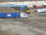 Looking N. from 127th St., the crew has added their two geeps to 3 units off the previous night's ethanol train, setting up the consist for the outbound west train, March 25, 2008.  In the background are those Werners, now loaded of course.