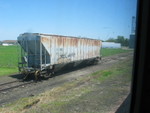 Bad order hopper set out on the Menlo elevator track.  Unfortunately the Canadian commuter cars don't have dutch doors so you have to shoot through the filty, scarred window, as is apparent in these shots...