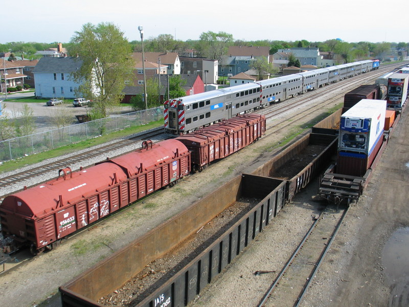 Inbound mainline express passes the IAIS's yard tracks at RI's old Burr Oak yard, below 127th St.  The 2 UP system covered gons were right behind the power on the departing westbound.