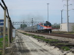 May 2, 2007. Looking north along the main line at Gresham as an outbound suburban train approaches.  Notice at right, the back of the 3 head signal controlling movements off the South Chicago line.