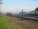 RISW crew has coupled onto the inbound turn and is pulling it around the "Iowa Main."  On the right are feed loads on t he "BN pass."