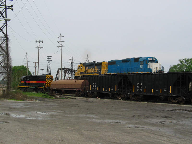 BN local heads for the Crescent Bridge while the IAIS Milan crew switches stone cars, May  10, 2006.