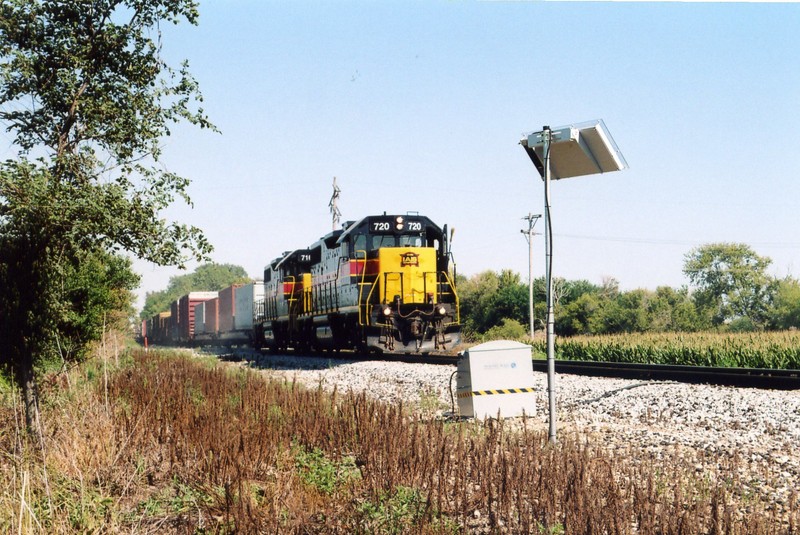 The westbound passes the solar powered flange greaser east of Durant, mp 200.5 or so.  Aug. 6, 2005