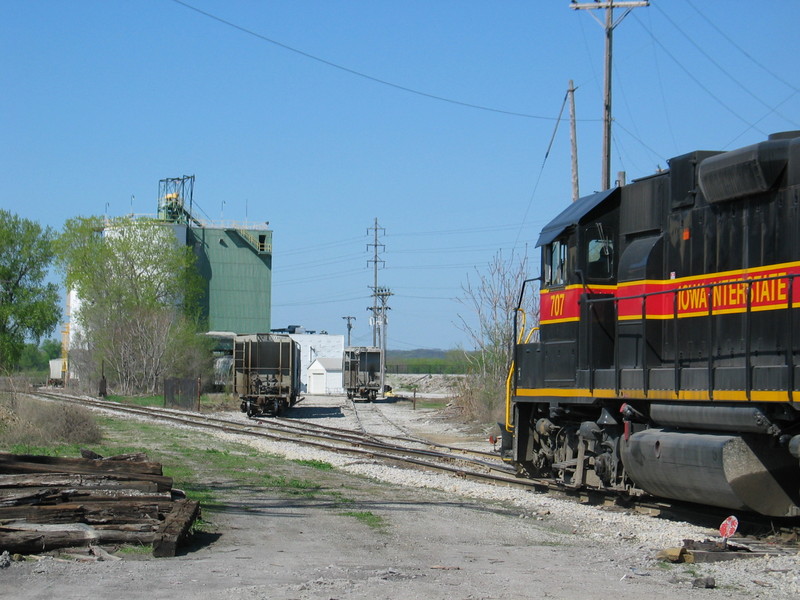 RI switcher backing out of Holcim Cement in Rock Island, after spotting in 3 loads.  April 21, 2006.