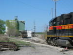 RI switcher backing out of Holcim Cement in Rock Island, after spotting in 3 loads.  April 21, 2006.