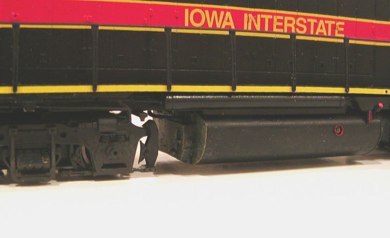 Fuel tank and trucks. I added a Hi-Tech Details waste fluid retention tank and a Cannon fuel tank detail set, using some spare parts from the latter to model the retention tank piping. The 700s have been kept fairly clean, so I limited my weathering to a little mud and grime on the trucks, fuel tank ends, and pilots. Trucks also received brake line detail.