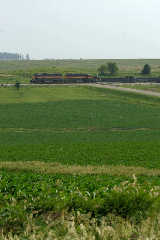 A reminder why it's called *Iowa* Interstate, as 627 rolls along through fields of young corn plants on this hazy afternoon