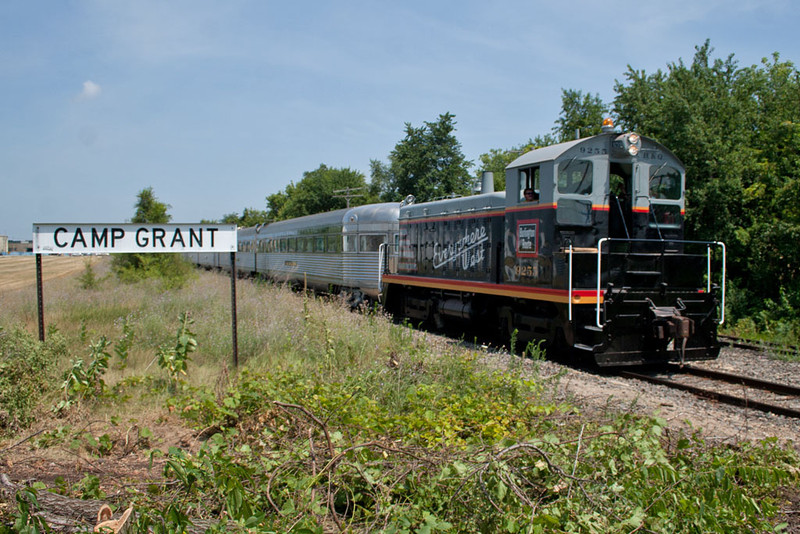 CB&Q 9255 pulls the Nebraska Zephyr south past the BN Camp Grant station sign near the Rockford, IL airport.