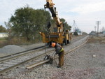 Preparing to swing the new rail over, ahead of the track gang.