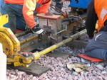 Packing clay into the space between the rail.