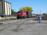 Tom McNair shoots at 44th.  In the background a BN track crew is assembling panel trackand a new switch.