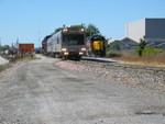 Heading west into RI yard on the Iowa main, while a switch crew works the BN side.