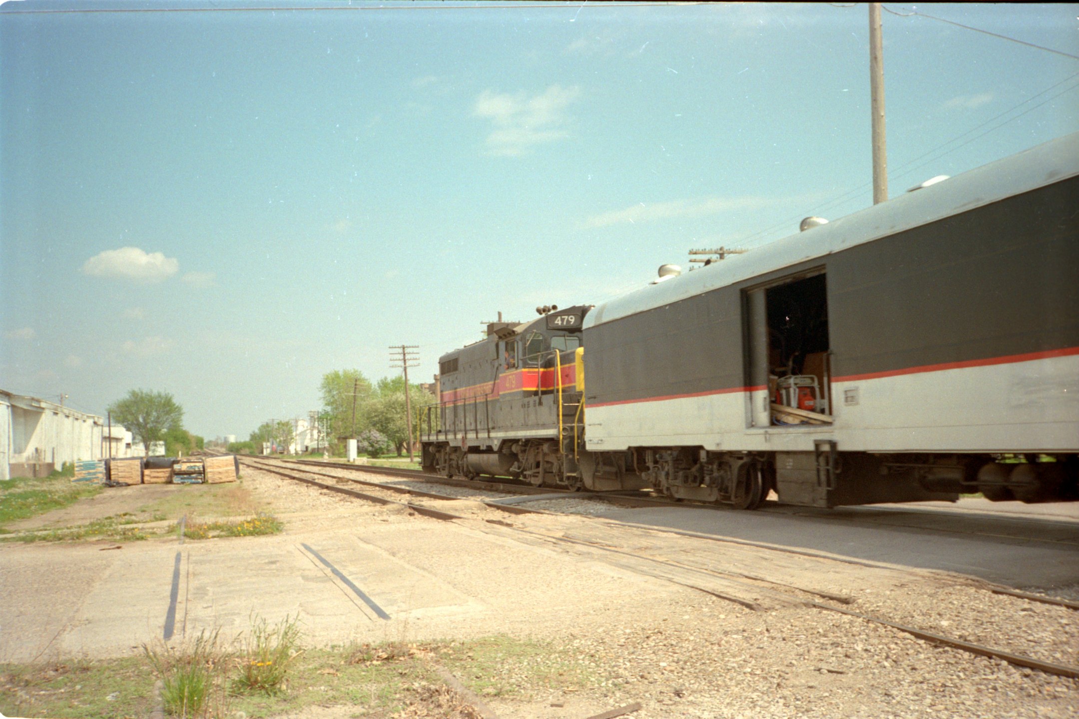 479 eastbound, clearly showing the ex-Milw baggage car open during the heat of summer