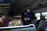 Volunteer Conductor Jerry Stauffer punches tickets.  1500 trip to Walcott behind IAIS 7081.
