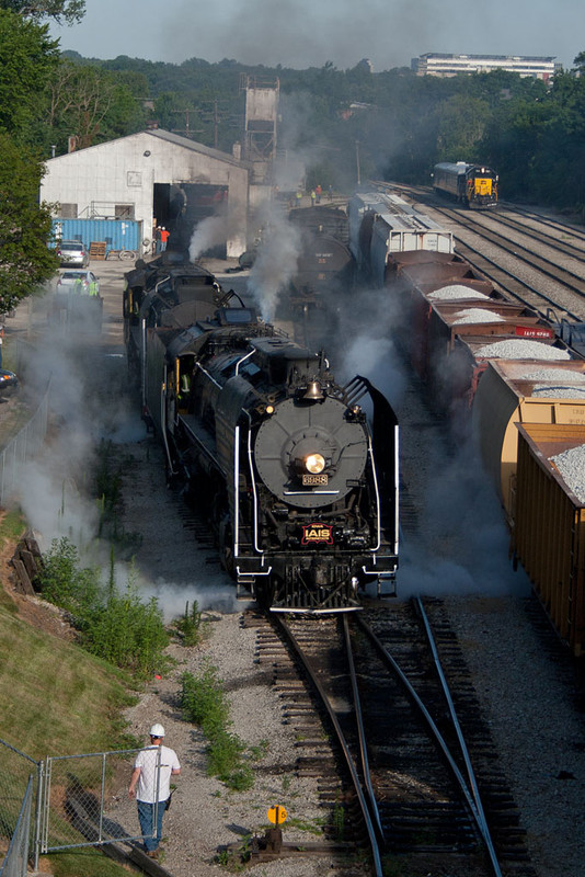 The QJ's pull out of the enginehouse in Iowa City with IAIS 701 and the business cars lurking in the background.