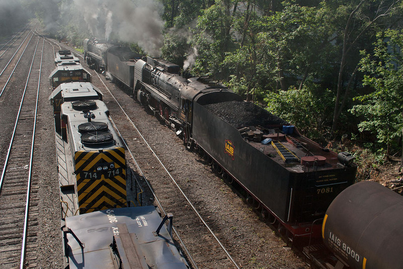 The QJ's head east for First Ave as IAIS 709 and IAIS 714 sit quietly.