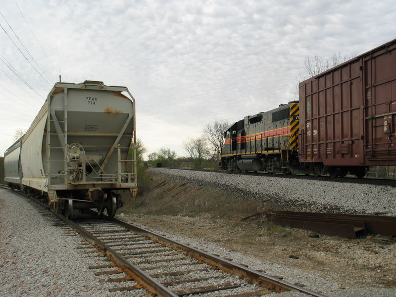 Local passes 2 setout hoppers from JM, at Yocum's west switch, April 15, 2006.