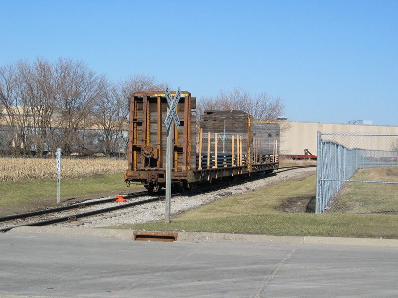 TTPX bulkhead flats waiting to be unloaded on Abassador's spur, Newton.  In the background is the IAIS main, plastic hoppers on the siding, and Maytag plant 2.  Jan. 12, 2006.