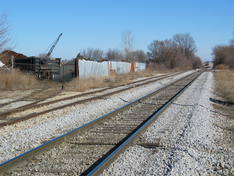 Scrap hopper (IAIS 6500 series) at Gralnek, in Newton.  In the background is the tail end of the eastbound on the siding.  Jan. 13, 2006.