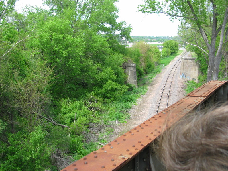 Photograph looking north at Rigg IA; the photographer is on the RI/IAIS track passing over the former Milw. now BN line to Bayard.  In the background are the piers from the former CGW line into the Bluffs.