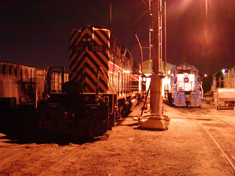 IAIS SD38-2 150, having arrived in CB for the first time following repainting at MAC in KC, rests alongside sister 2809 east of the Bluffs enginehouse.