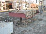 Homemade work table outside the shop, with legs made from old locomotive and car wheels and axles, 2/18/2012.